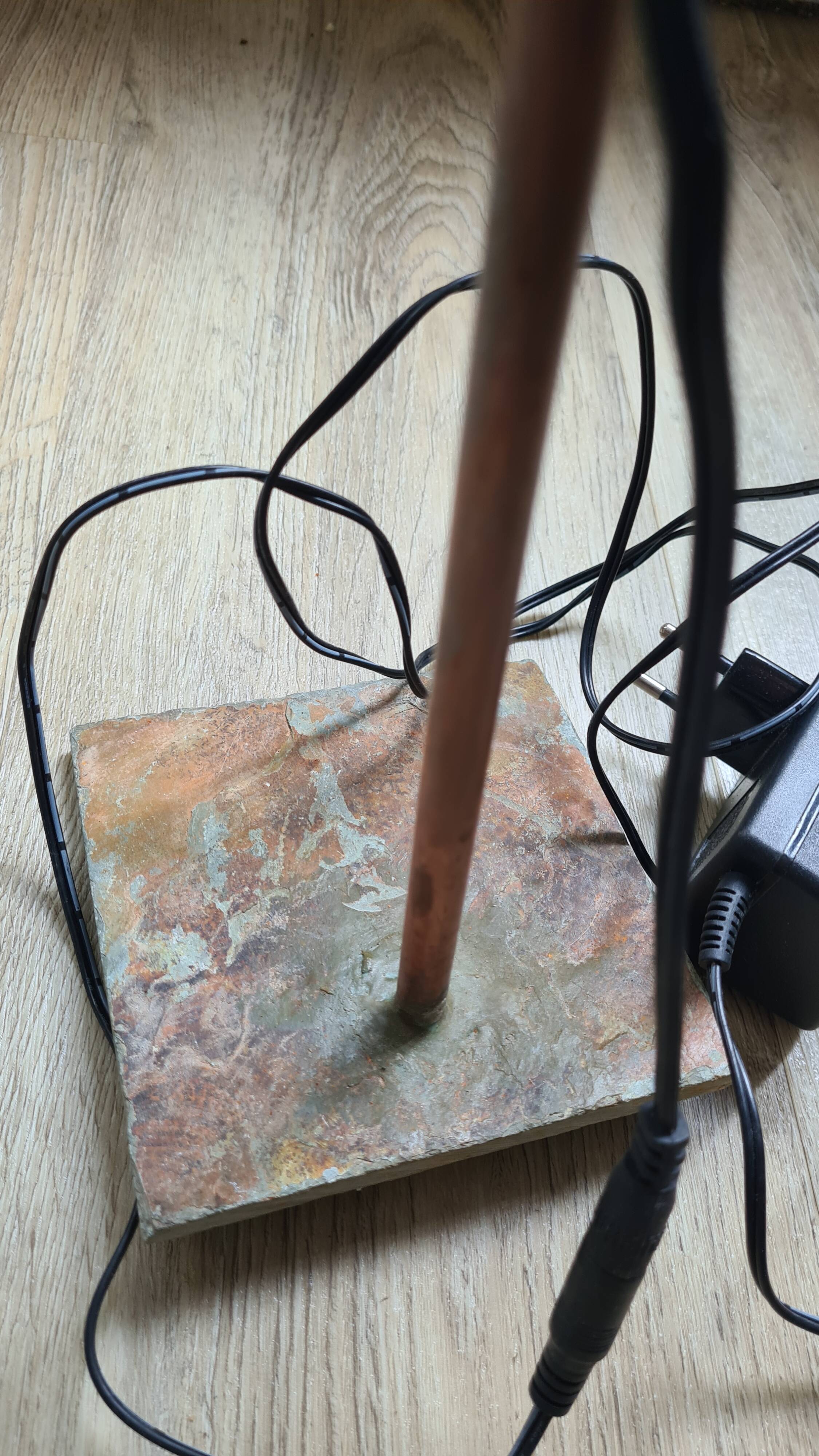 old lamp with stone base and copper arm