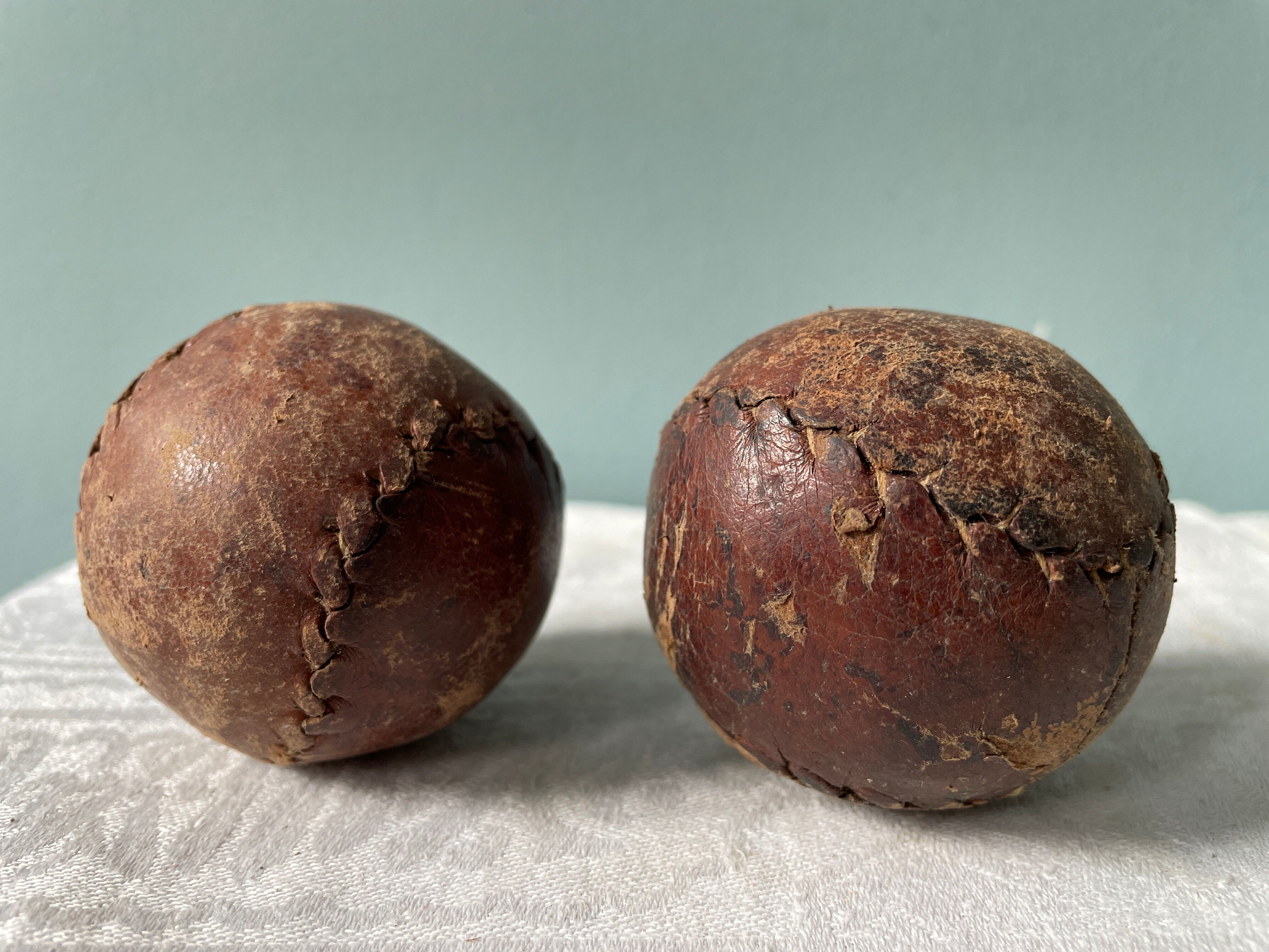 Two old nineteenth century leather golf balls