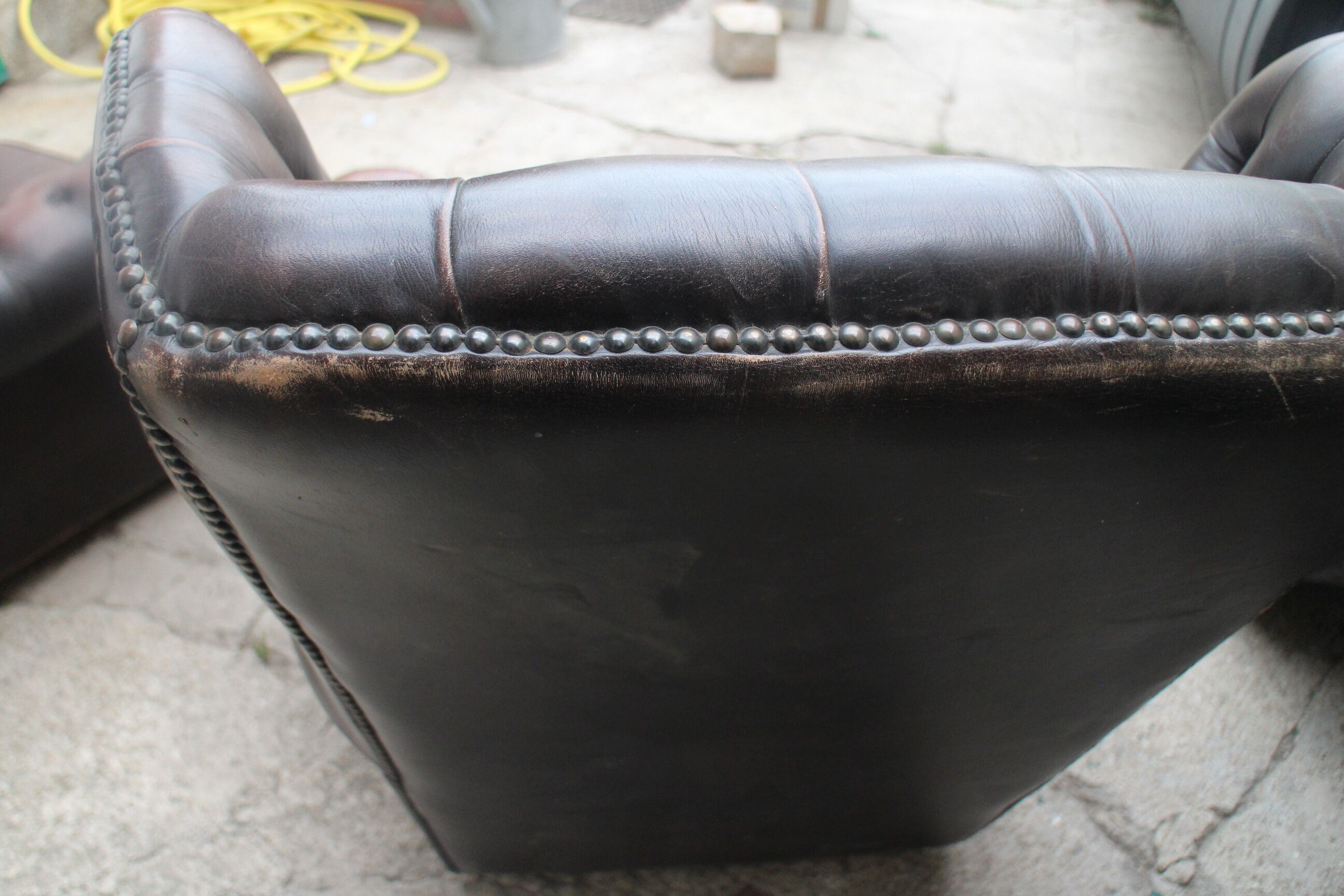 Padded chesterfield leather armchairs