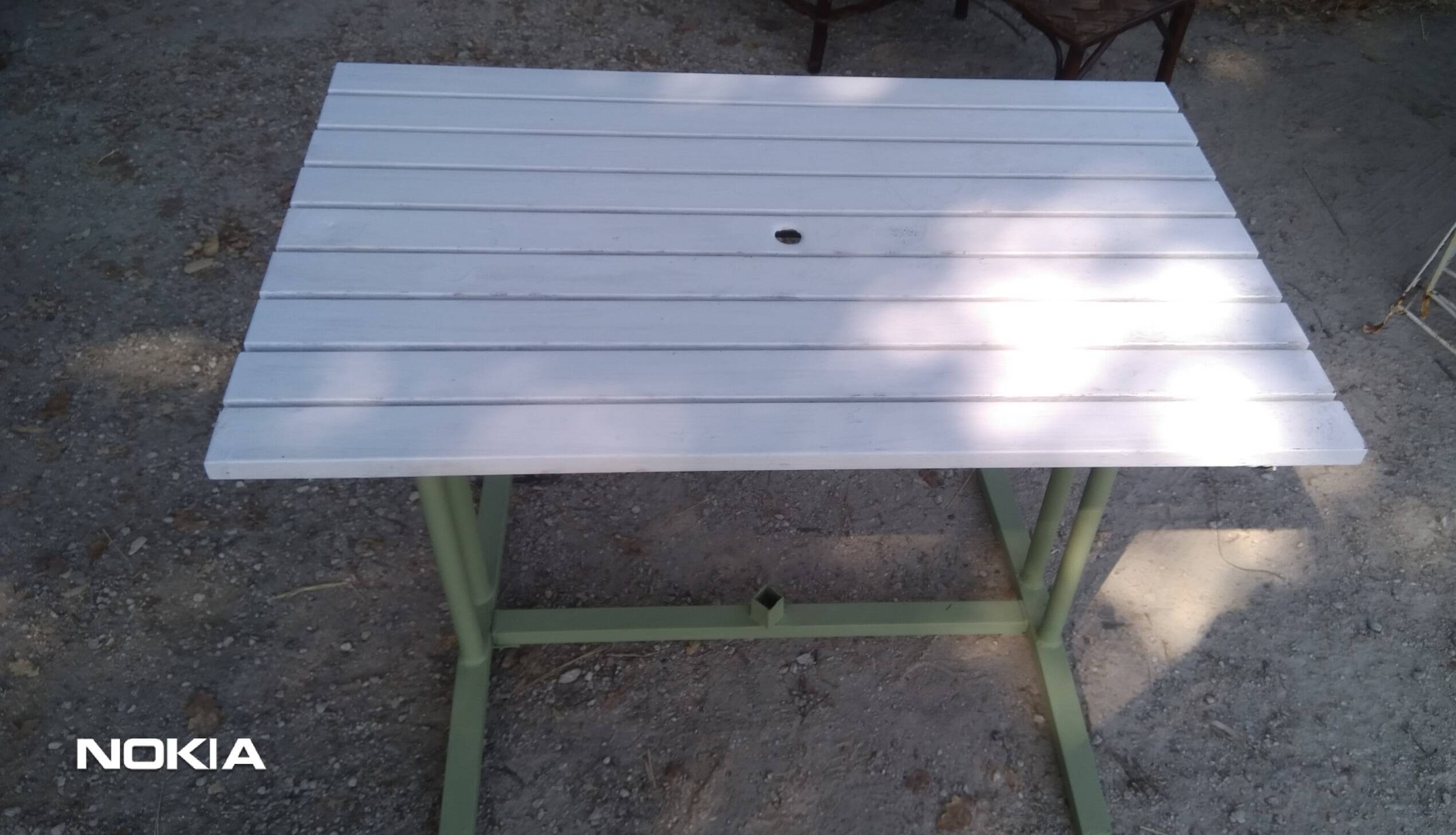 Old garden table with iron slats