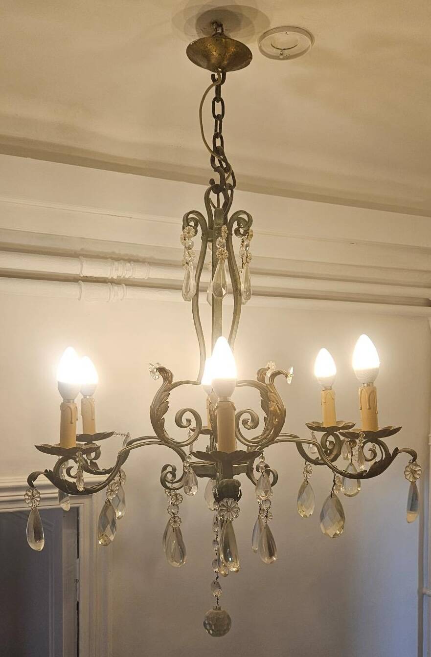 Antique wrought iron chandelier with 6 lights and pendants.