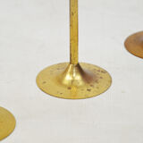 A set of three golden candlesticks, 1970s