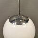 White hanging lamp with metal suspension, made with ball round opal glass shade.