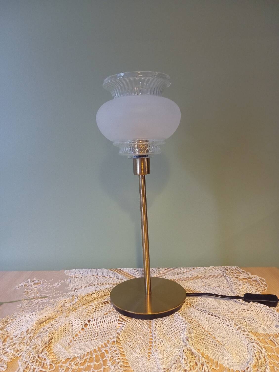 Table lamp with gold metal base and vintage white glass lampshade