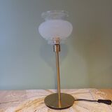 Table lamp with gold metal base and vintage white glass lampshade