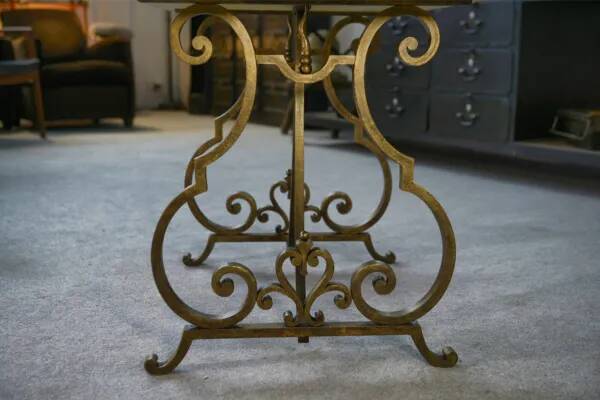 Side table with a gilt wrought iron base attributed to Gilbert Poillerat, with a travertine top, 1940s