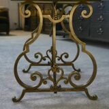 Side table with a gilt wrought iron base attributed to Gilbert Poillerat, with a travertine top, 1940s