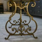 Side table with a gilt wrought iron base attributed to Gilbert Poillerat, with a travertine top, 1940s