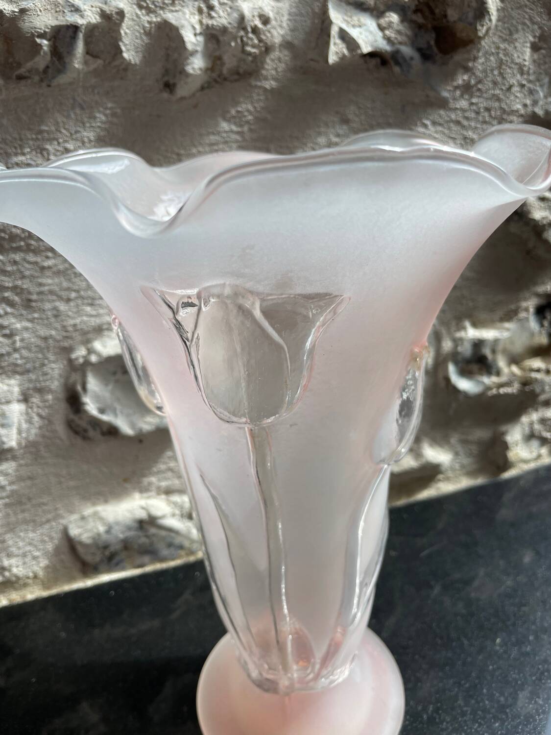 Pink glass vase decorated with tulips