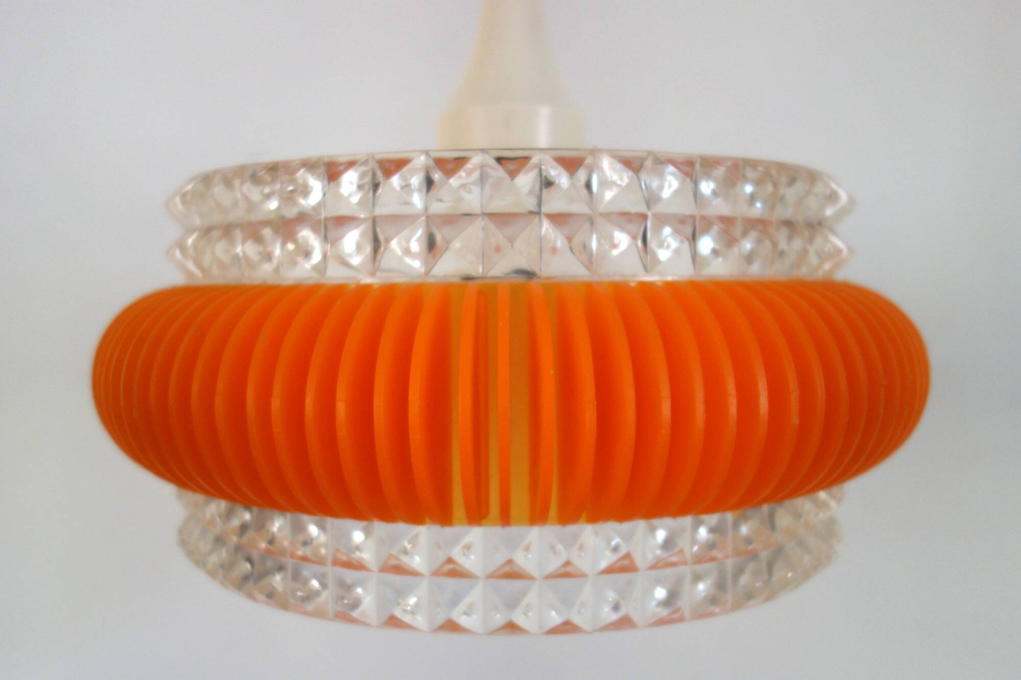 Transparent plastic space age lustre with orange band from the 70s.