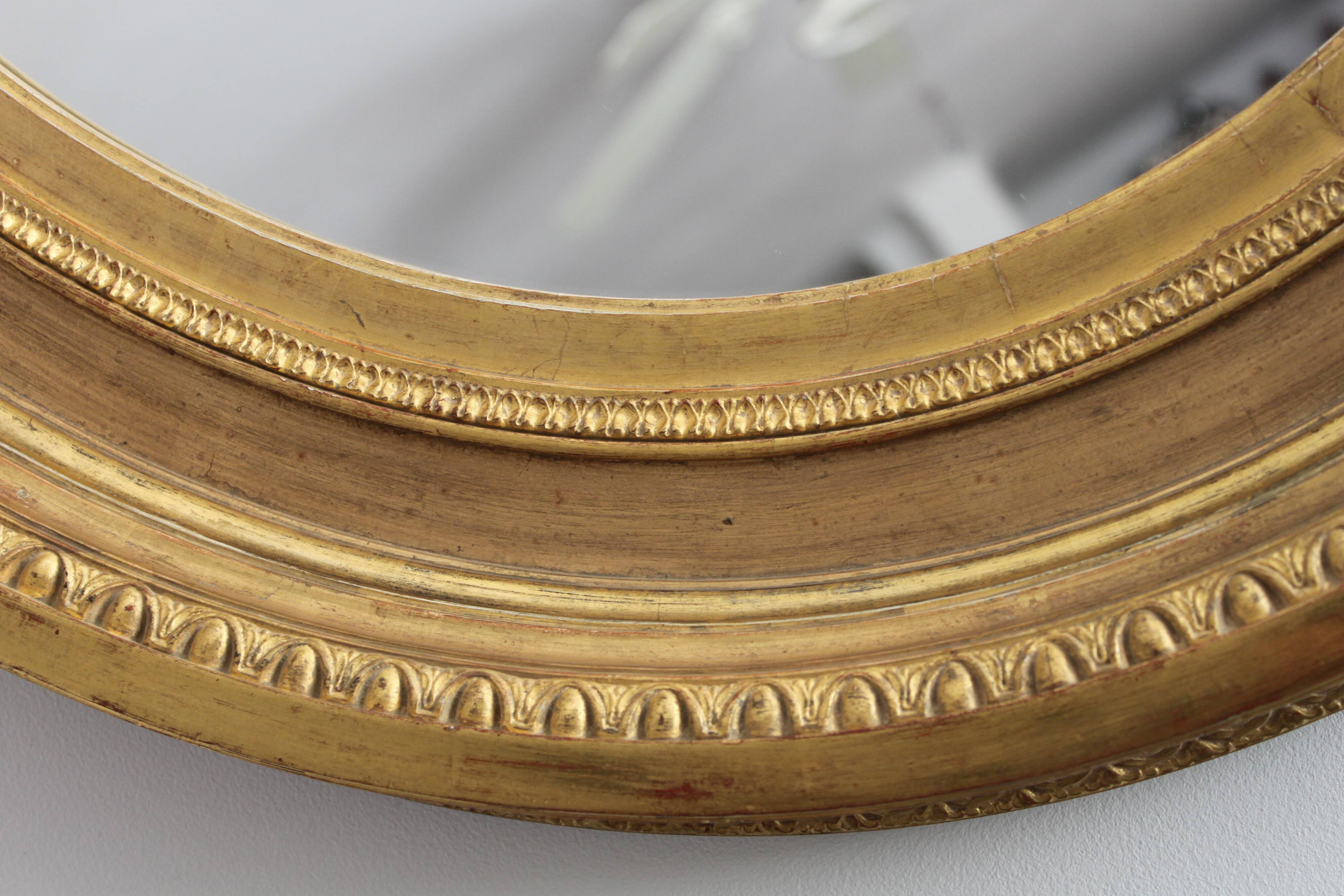 Mirror antique medallion gilded with gold leaf