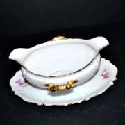 Vintage pouring sauce boat in floral porcelain with gilding.