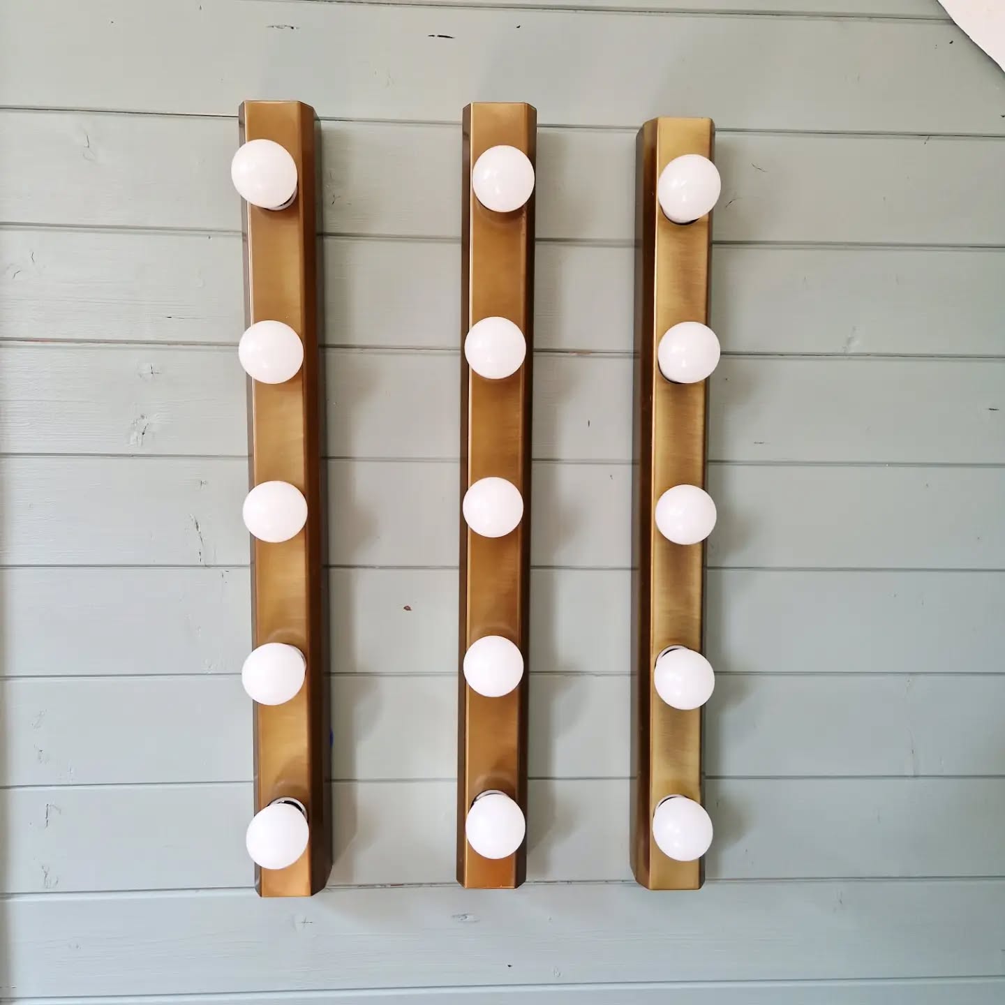Set of three wall sconces in solid brass, 1970s-80s.