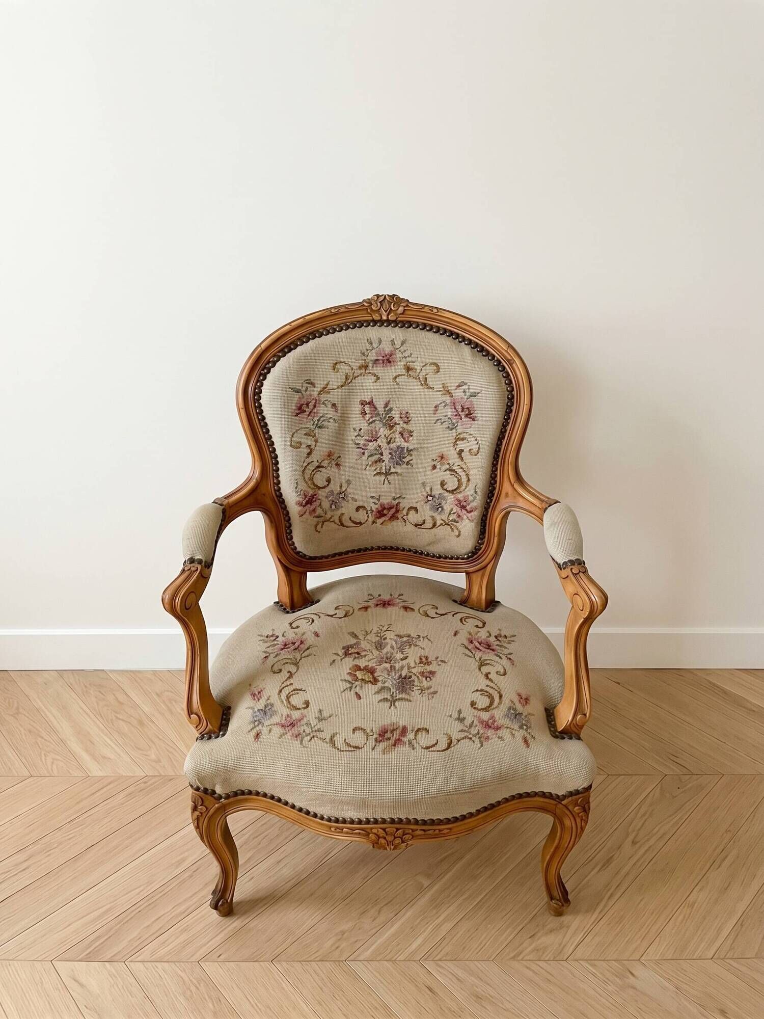 Pair of Louis XV/XVI armchairs in carved wood and floral fabric.