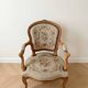 Pair of Louis XV/XVI armchairs in carved wood and floral fabric.