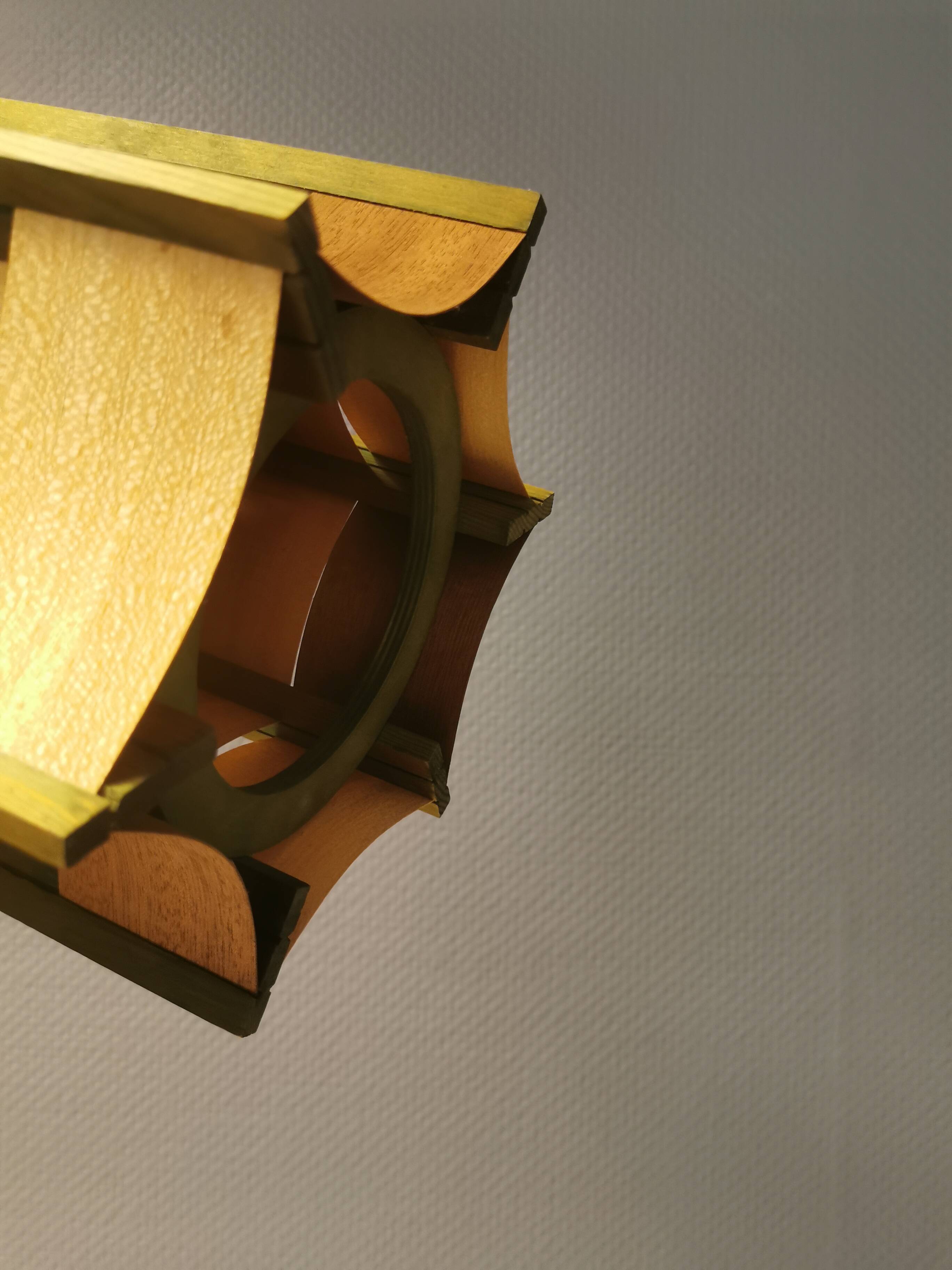 Older lamp in wood veneer, partially painted in green colour.