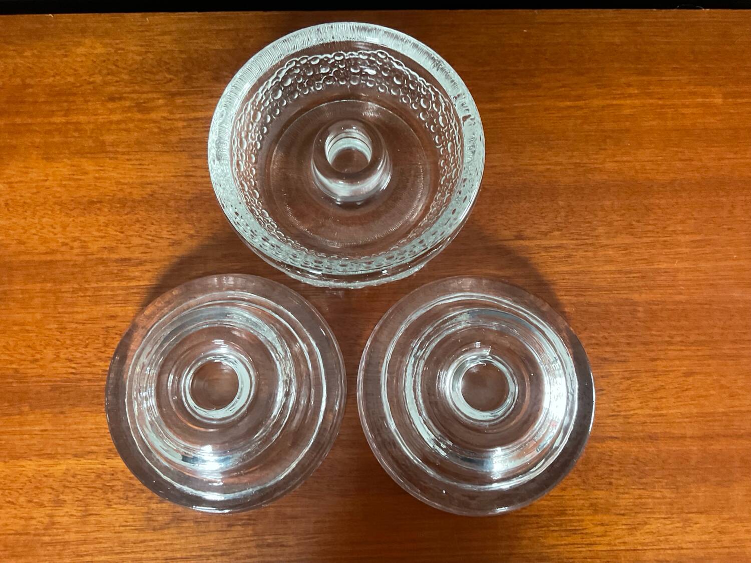 Set of three round thick moulded glass candle holders