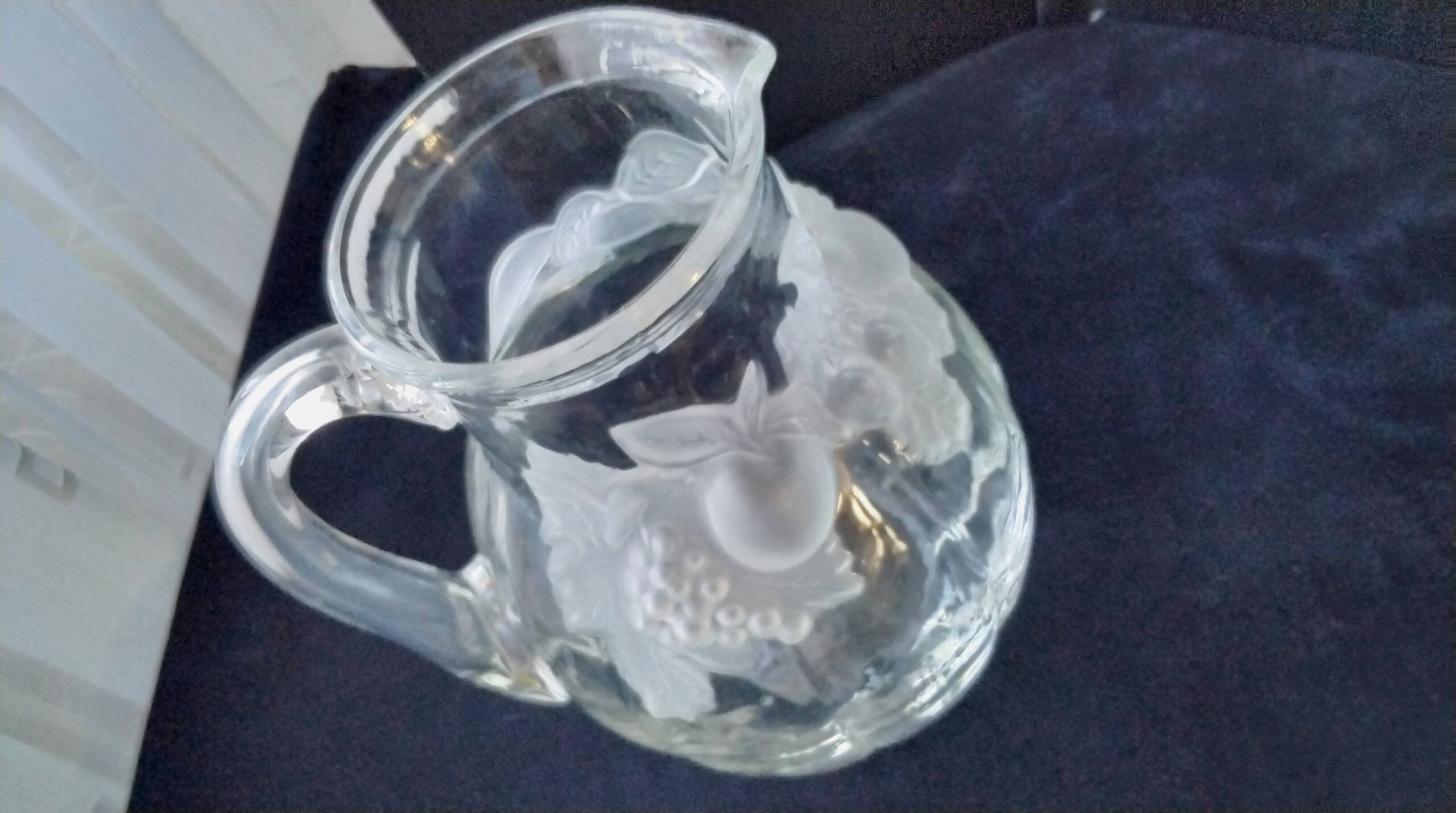 Large water jug with embossed fruit decoration in frosted glass