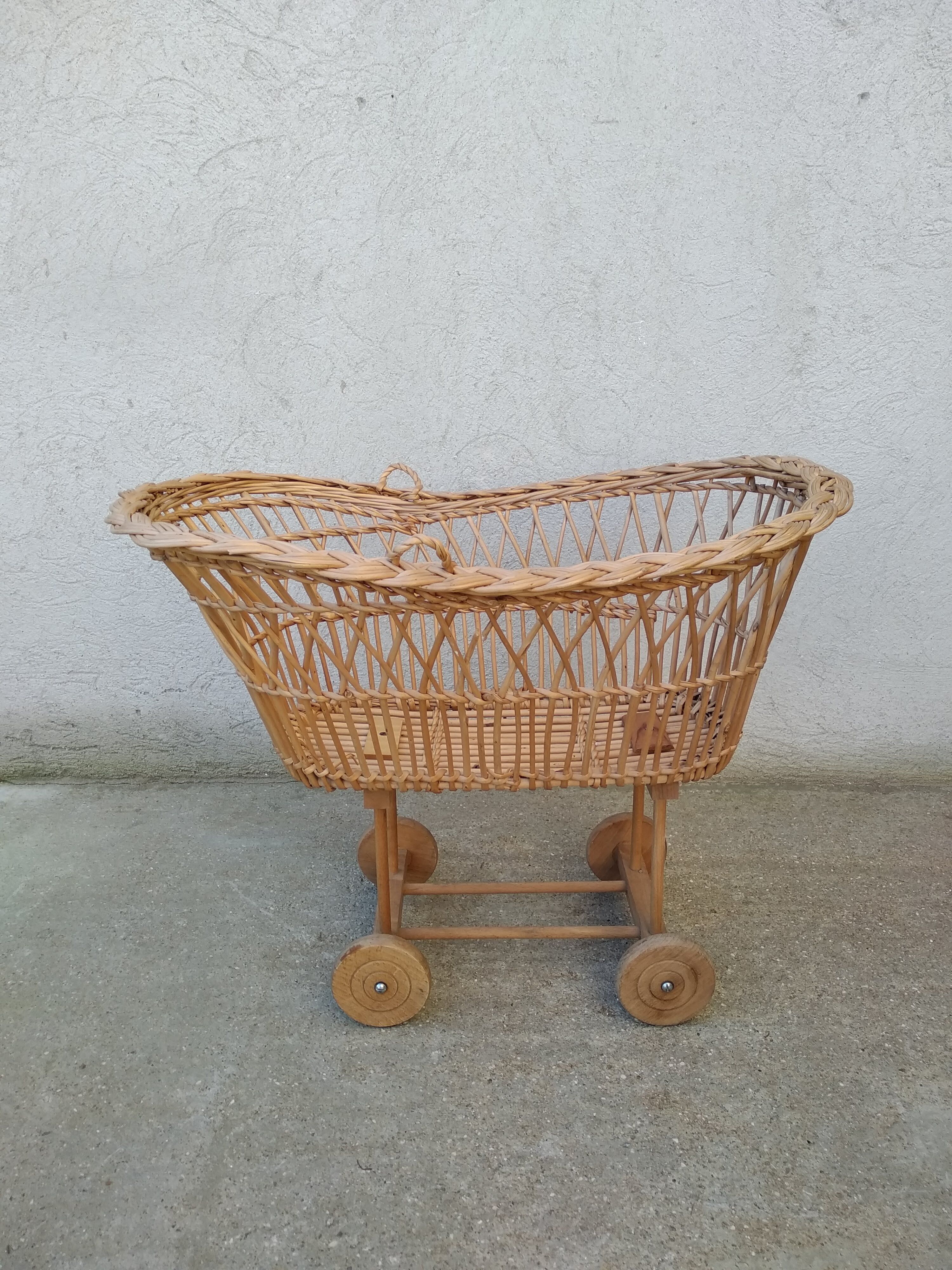 Rattan cradle for doll on vintage wheels
