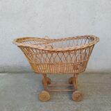 Rattan cradle for doll on vintage wheels