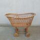 Rattan cradle for doll on vintage wheels