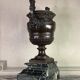 Patinated bronze vase with handles topped by bicéphalic busts, 19th century.