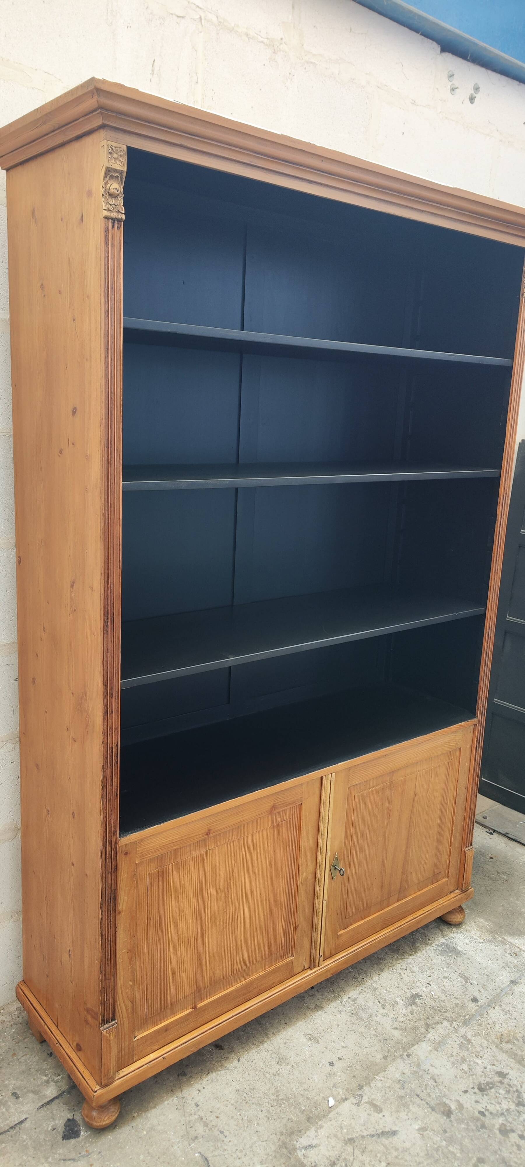 Large waxed pine bookcase with two doors