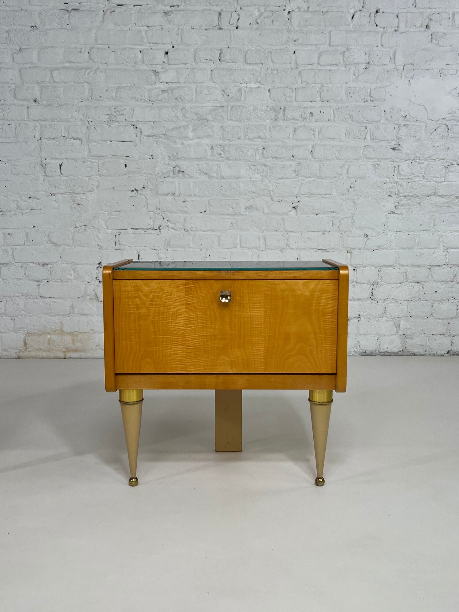 Pair of bedside tables in wood, brass and black glass top