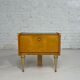 Pair of bedside tables in wood, brass and black glass top