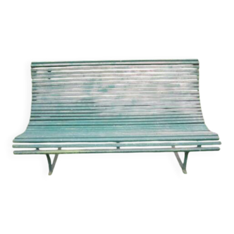 Old metal garden bench with wooden slats