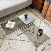 Set of 2 vintage nesting coffee tables in chrome metal and smoked glass.