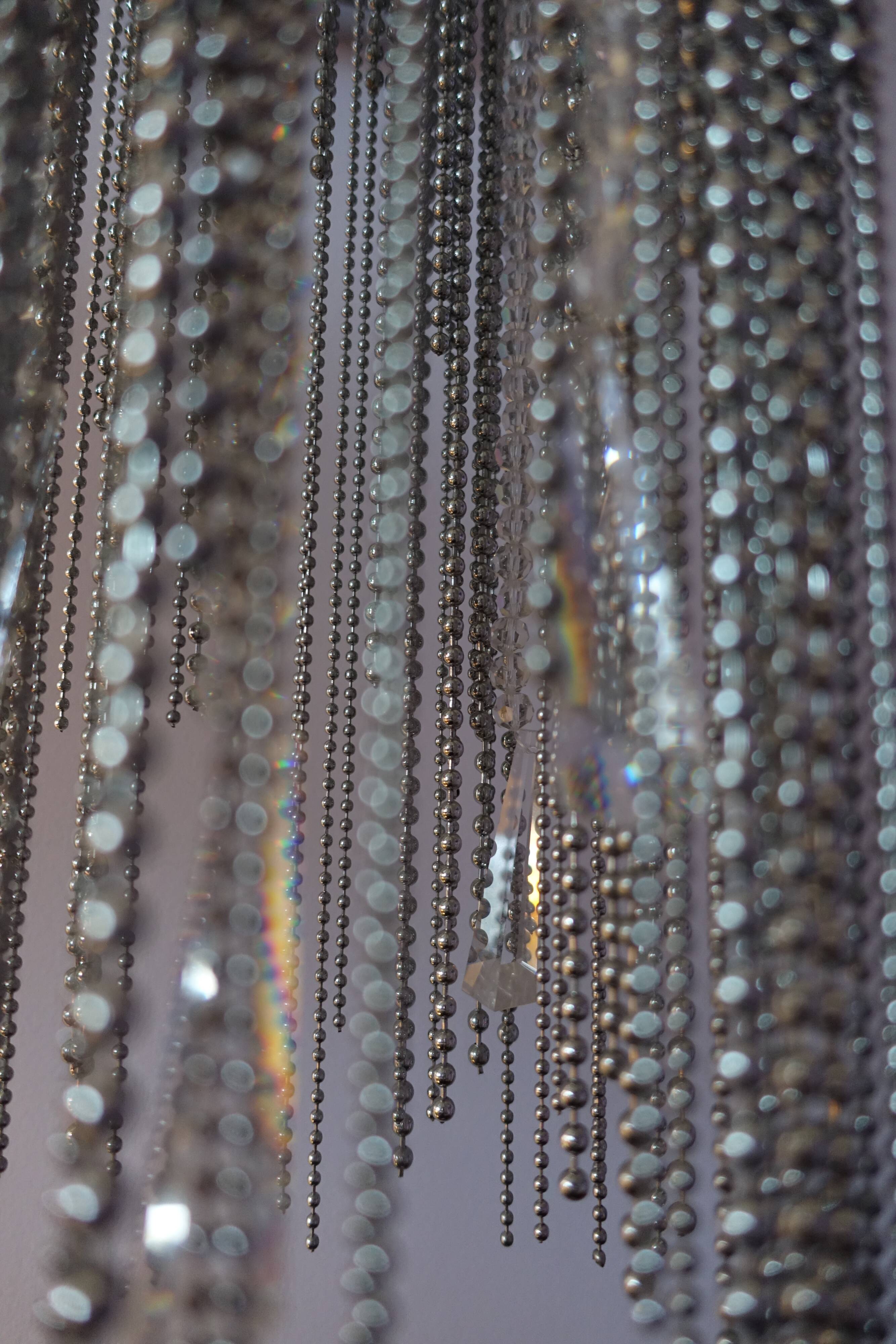 Swarovski wall lamp in silver-plated metal with crystal pendants.