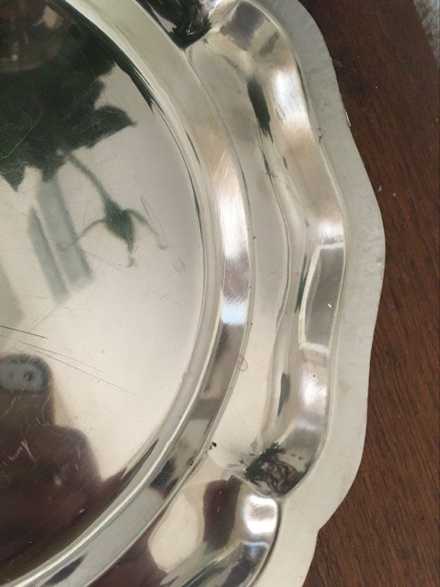 Two matching round dishes in stainless steel