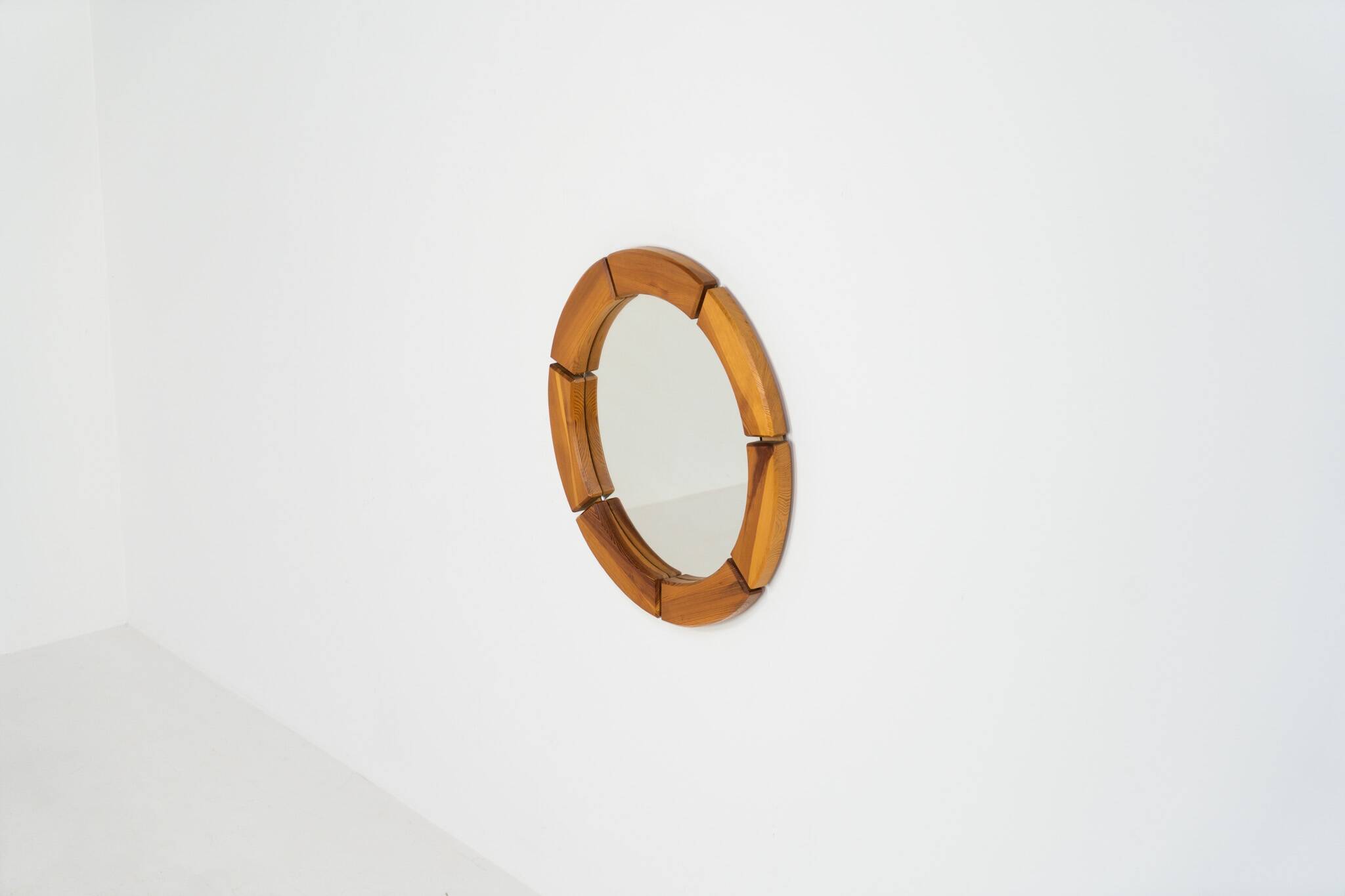 Sculptural wall mirror in solid pine