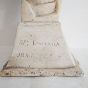Bust of woman in plaster on pedestal with inscription