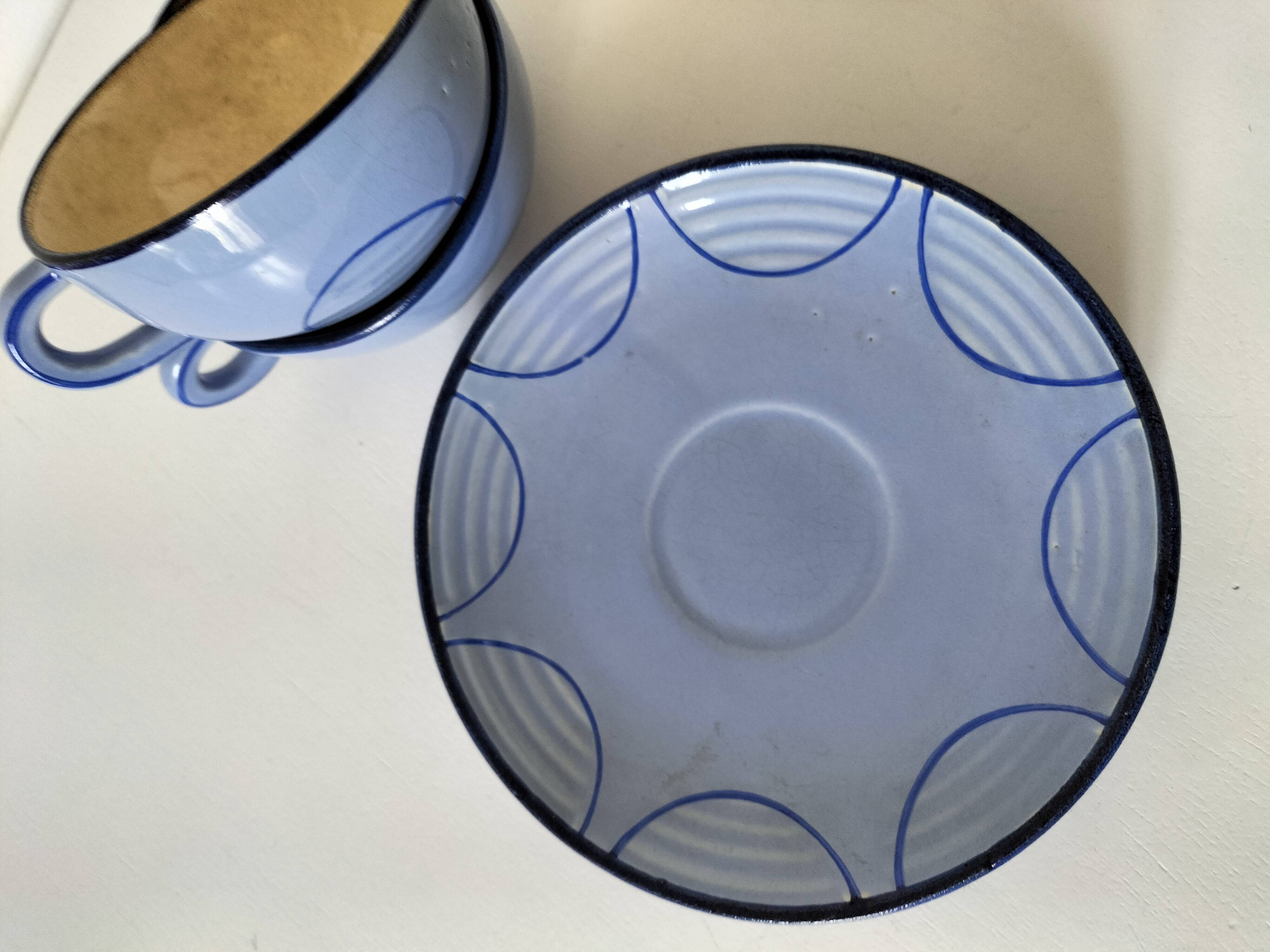 A pair of glazed ceramic cups and saucers from the 60s-70s.