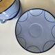 A pair of glazed ceramic cups and saucers from the 60s-70s.