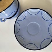 A pair of glazed ceramic cups and saucers from the 60s-70s.