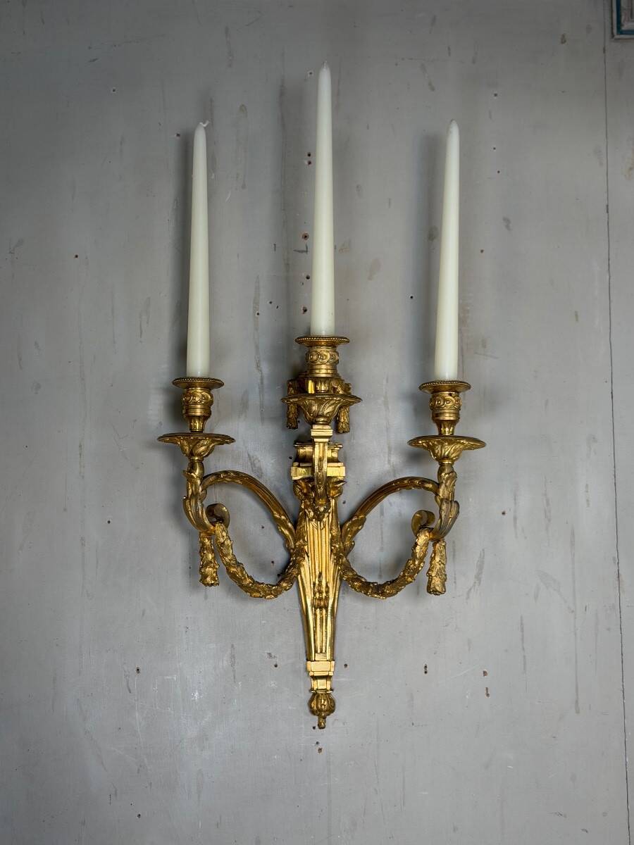 Pair of Louis XVI style wall sconces in gilded bronze, circa 1880.