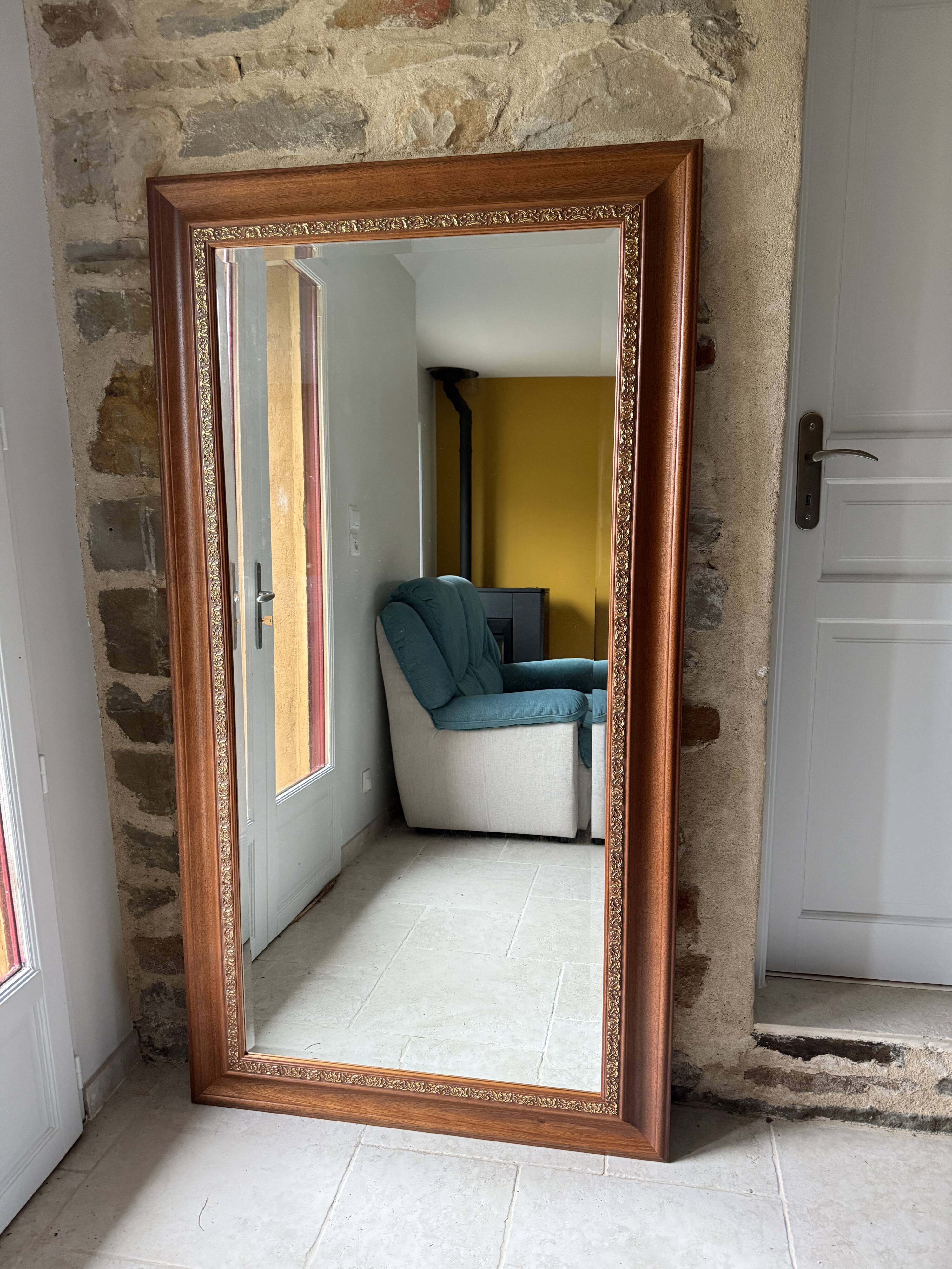 Large bevelled tabletop mirror in carved gilded wood.