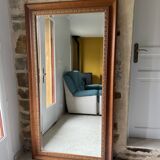 Large bevelled tabletop mirror in carved gilded wood.