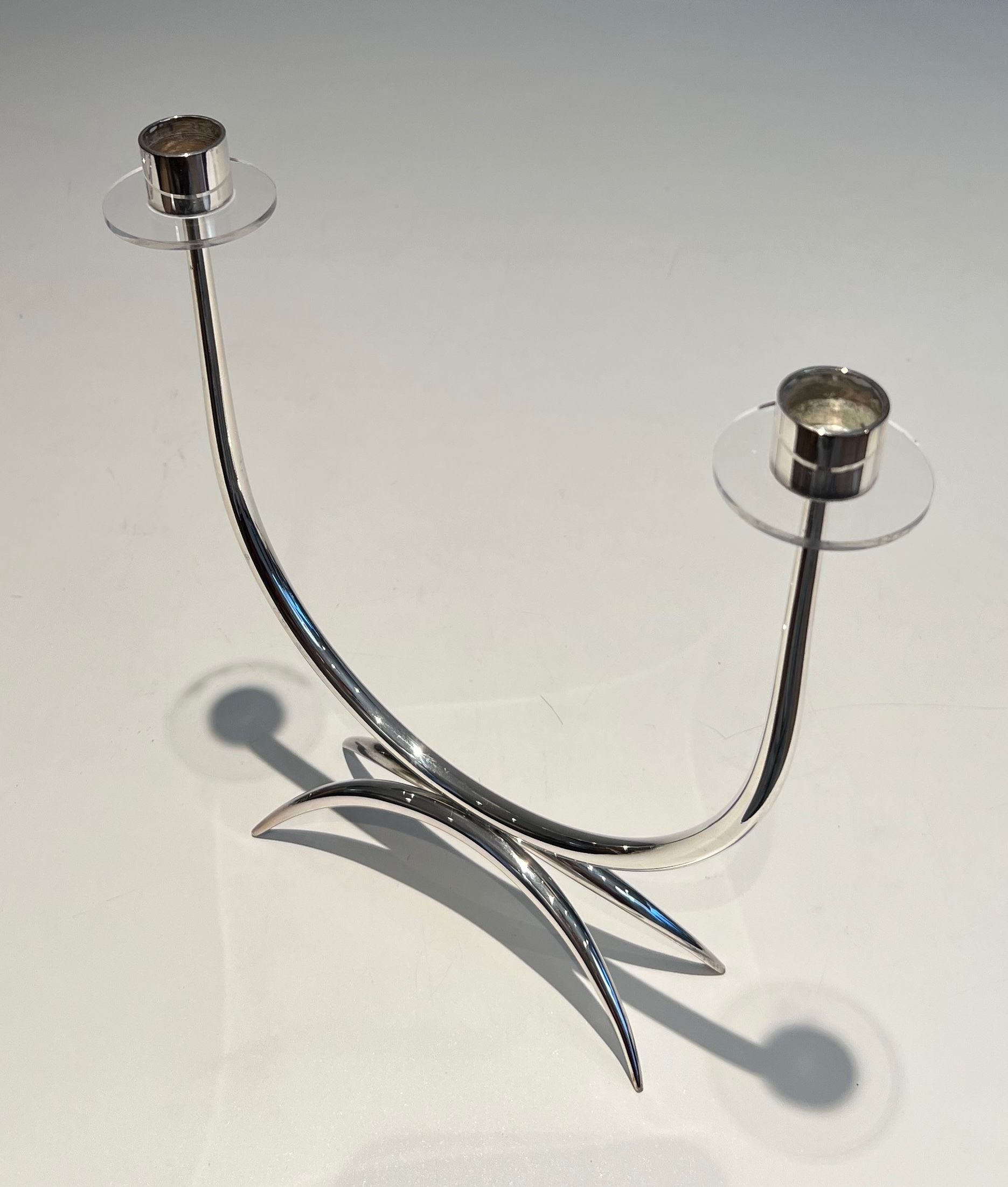 Silver-plated metal and plexiglass design candlestick.