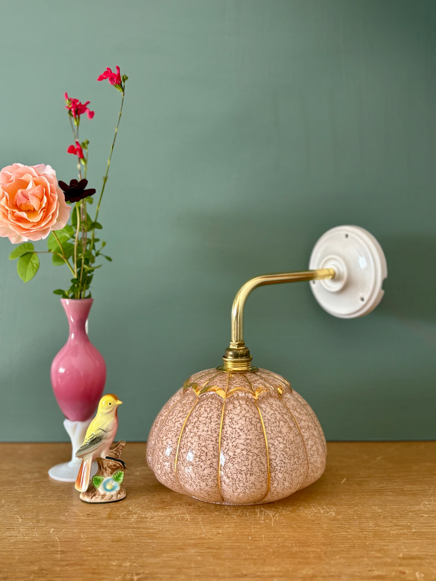 Vintage glass wall light with a pink and gold Clichy globe.