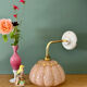 Vintage glass wall light with a pink and gold Clichy globe.