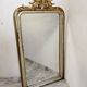 Antique mirror with a gilded frame and cherubs.