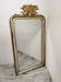 Antique mirror with a gilded frame and cherubs.