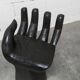 Black armchair chair in carved wood in the shape of a hand
