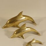 Three brass dolphins