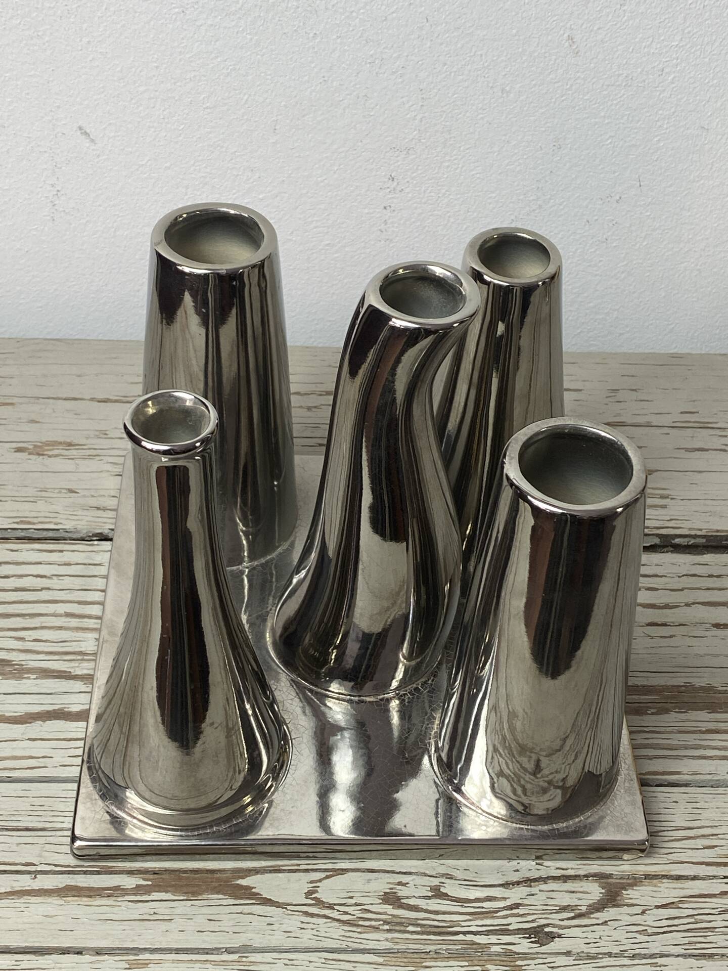 Asymmetrical multitube vase on a base, in silvered ceramic, 1970.