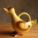 Ceramic watering can in white earthenware, yellow enamel and bird shape